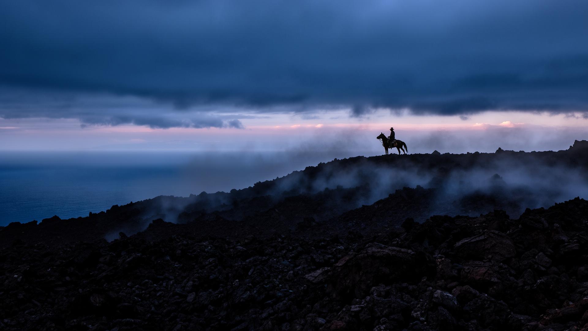 A lone rider against a watchfire on the frontier line